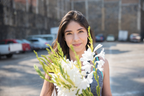 Young woman holding flowers Mexico City Mexico