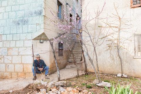 old man sitting outside in croatian village